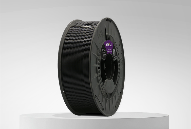 Spool of Winkle PLA High Speed Filament Jet Black 1,75mm 1kg on a platform and gray background