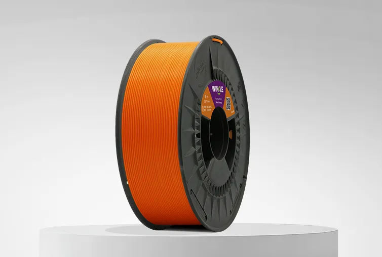 Spool of Winkle PLA HD Filament Nemo Orange 1,75mm 1kg on a platform and gray background