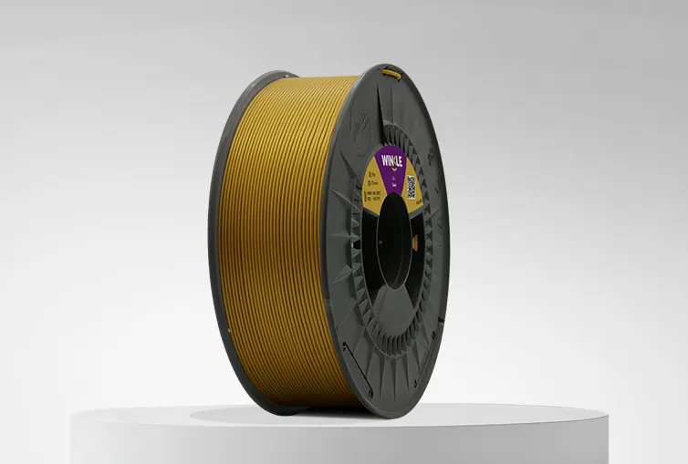 Spool of Winkle PLA HD Filament Gold 1,75mm 1kg on a platform and gray background