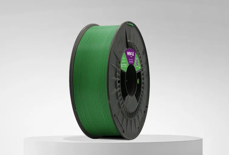 Spool of Winkle PLA HD Filament Avocado Green 1,75mm 1kg on a platform and gray background