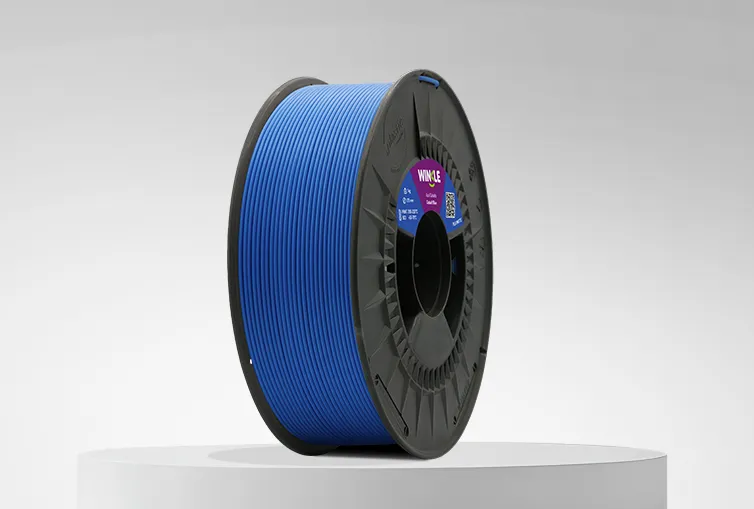 Spool of Winkle PLA Matte Filament Cobalt Blue 1,75mm 1kg on a platform and gray background