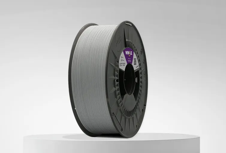 Spool of Winkle PLA Matte Filament Smoke Grey 1,75mm 1kg on a platform and gray background