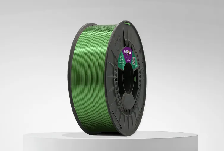 Spool of Winkle PLA Silk Filament Irish Green 1,75mm 1kg on a platform and gray background